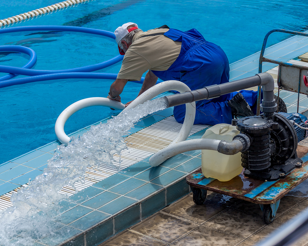 Cleaning the sports pool with a cleaning water pump. The water pump filters the water from the bottom of the pool, cleans from dirt and debris. The cleaning pump works with the pool.